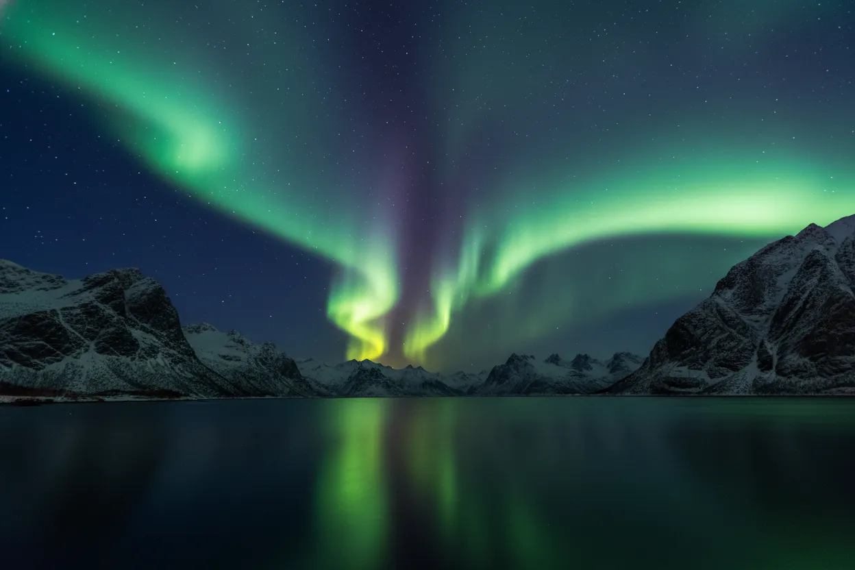Aurora borealis dancing over a frozen Norwegian fjord at midnight