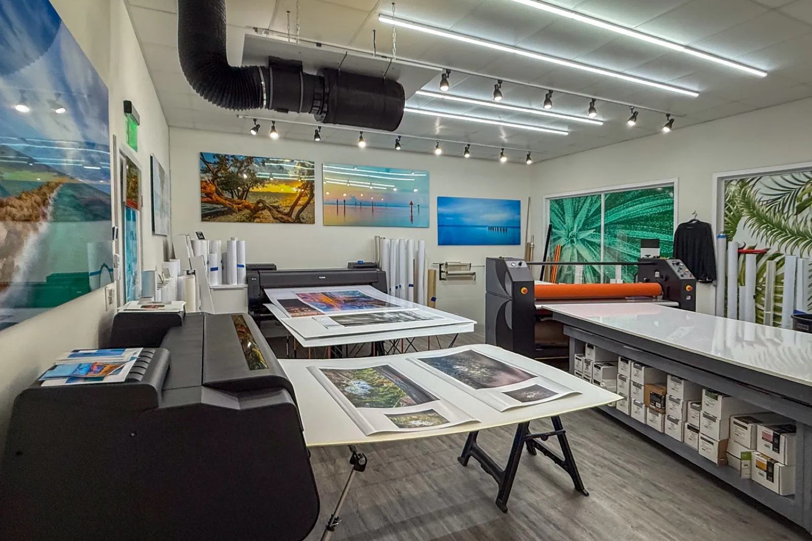 Print studio workspace with finished pieces on the wall